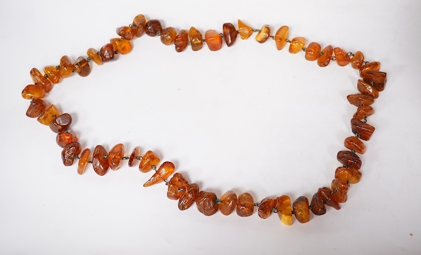 Three assorted amber necklaces including a single strand graduated oval bead necklace, 40cm, gross weight 37 grams, the other two necklaces gross weight 240 grams. Condition - poor to fair